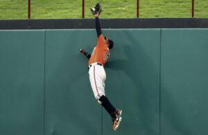 Baltimore Orioles CF Adam Jones flies high over the wall to rob a home run.