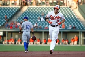 Chris Davis rounds the bases with Rougned Odor in the background.