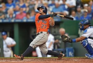 The Astros' Jose Altuve watches after swinging.