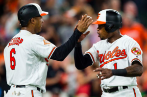 Tim Beckham and Jonathan Schoop high five.